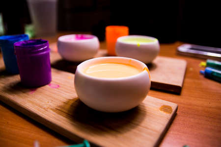 palette with blue, red, pink paint on a wooden baseの写真素材