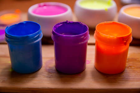 palette with blue, red, pink paint on a wooden baseの写真素材