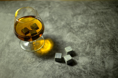 transparent whiskey on a dark background. whiskey stones in a glassの写真素材