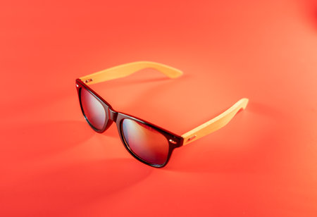 sunglasses for leisure and travel on a red backgroundの写真素材