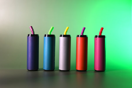 Multi-colored electronic cigarettes for vaping on a green backgroundの写真素材