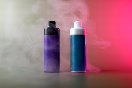 Multi-colored electronic cigarettes for vaping on a pink backgroundの写真素材