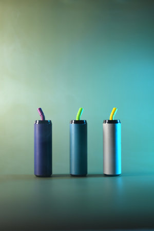 Multi-colored electronic cigarettes for vaping on a gray backgroundの写真素材