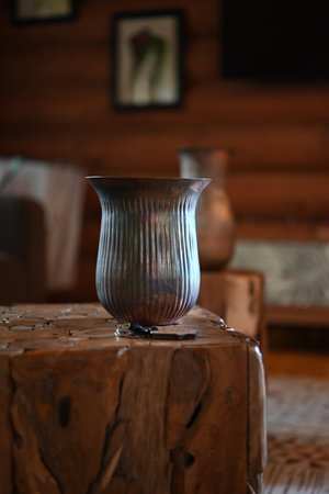 cast iron vase on a wooden surface in the roomの写真素材