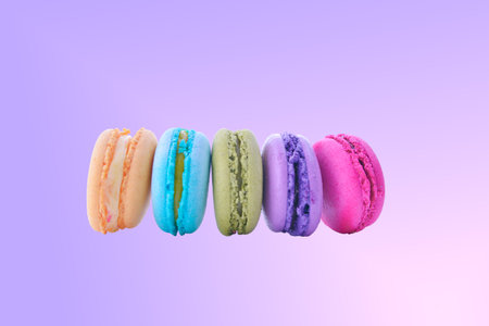 colorful macaroni on pink gradient backgroundの写真素材