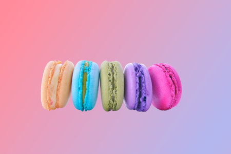 colorful macarons on pink gradient backgroundの写真素材