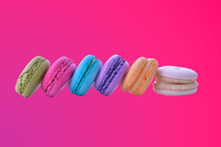 colorful macarons on pink gradient backgroundの写真素材