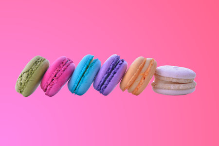 colorful macarons on pink gradient backgroundの写真素材
