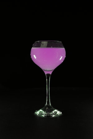 glass with pink cocktail on black backgroundの写真素材