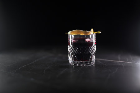 cocktail in a clear glass with orange peelの写真素材