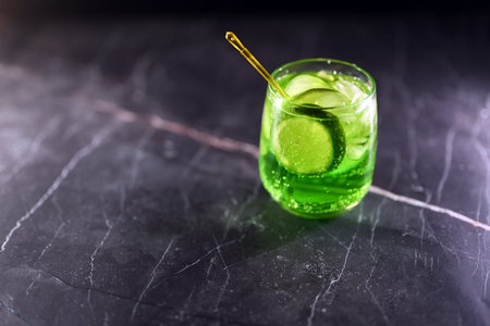 Mojito cocktail with lime wedges and ice on black backgroundの写真素材