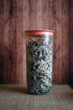 dry mint in food container on wooden backgroundの写真素材