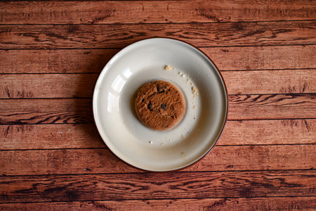 oatmeal cookies on a white saucer on a wooden tableの写真素材