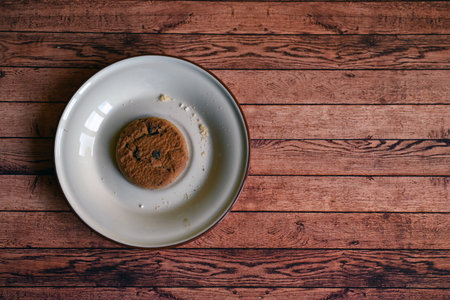oatmeal cookies on a white saucer on a wooden tableの写真素材