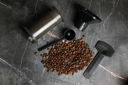 Coffee press with hot coffee and roasted beans on a dark backgroundの写真素材