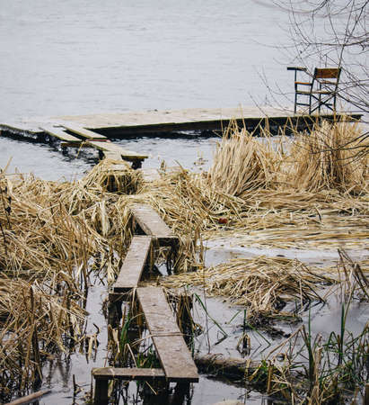 A young man in camouflage and a backpack in the mountainsの写真素材