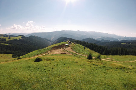 A young man in camouflage and a backpack in the mountainsの写真素材