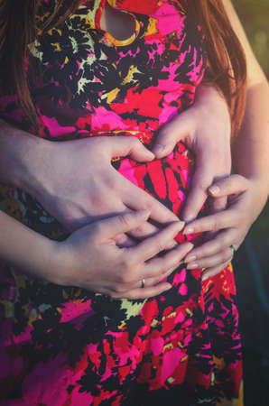 A young man in camouflage and a backpack in the mountainsの写真素材