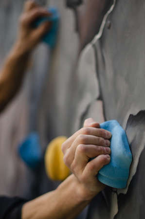 A young man in camouflage and a backpack in the mountainsの写真素材