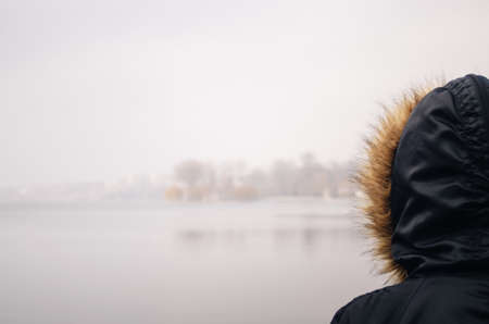 A young man in camouflage and a backpack in the mountainsの写真素材