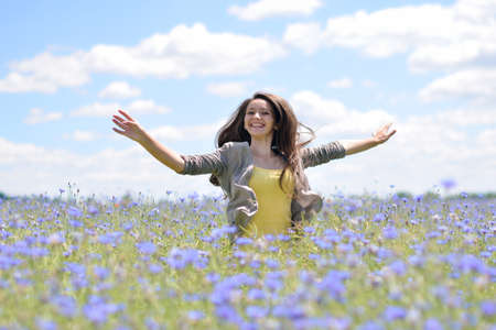 A young man in camouflage and a backpack in the mountainsの写真素材