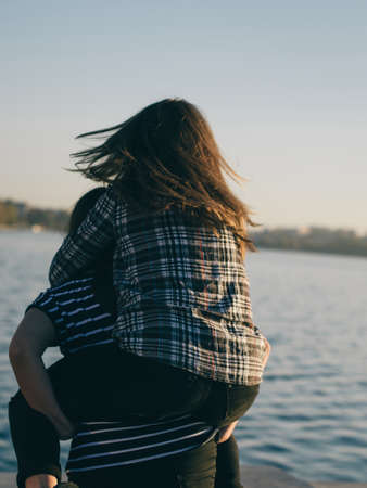 A young man in camouflage and a backpack in the mountainsの写真素材