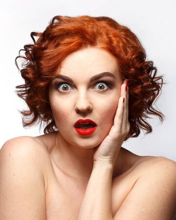 Surprised young woman with eyes wide openの写真素材