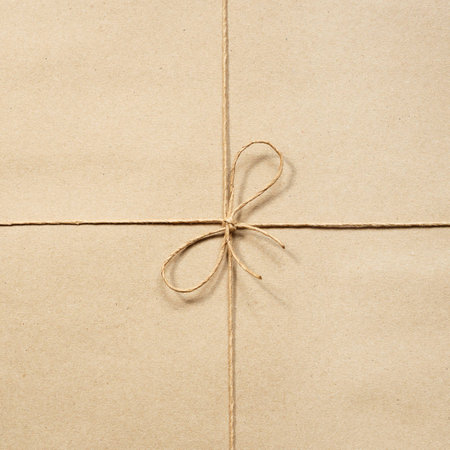Paper rope, knotted at the wrapping paper beigeの写真素材