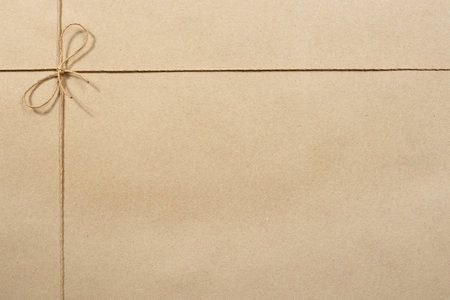 Beige packing paper, paper tied with a ropeの写真素材