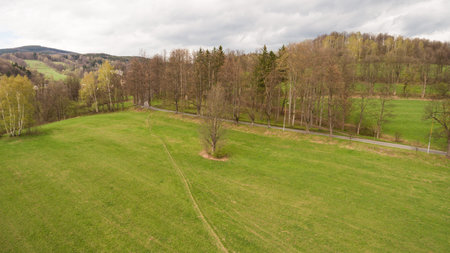 Aerial View. Panorama over a green grassy in mountains.
