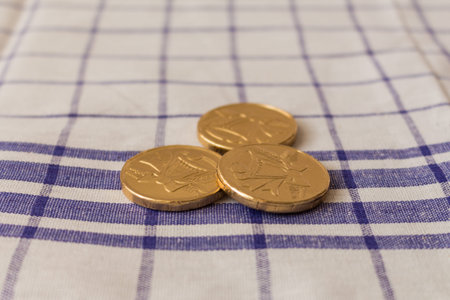 A lot of modern coins with bells. Coins with square pattern on cloth.