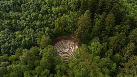 Aerial view of a maze in a park in the middle of a lush forest.の写真素材