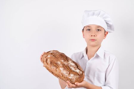 Cook Boy With rustic Bread on white background.の写真素材