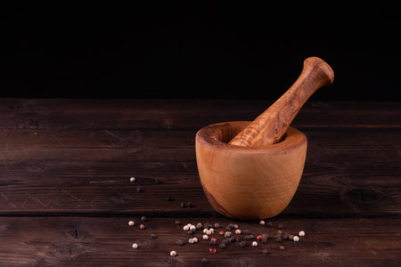 wooden mortar with pepper, low key, olive wood, rusticの写真素材