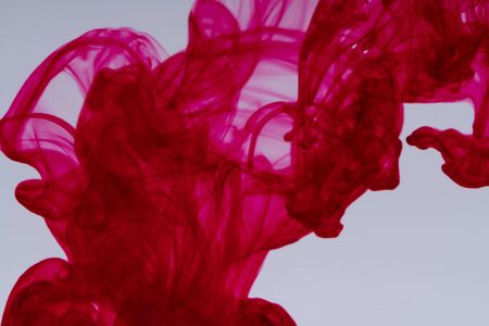 Cloud of ink in water on white backgroundの写真素材
