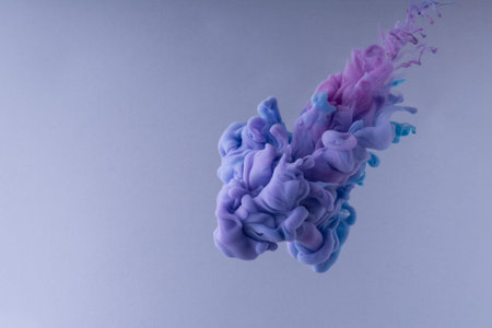 Colorful Ink swirling in water. Cloud of silky ink on white background.