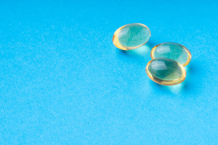 omega3 pills on a blue background. clouse up