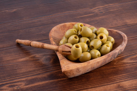 Plate heart shape on a wooden background, low key, hand made, rusticの写真素材