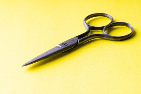 vintage scissors on a yellow backgroundの写真素材