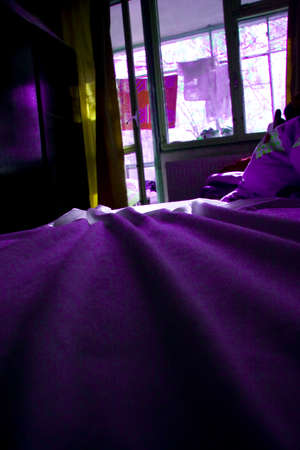 Bedroom with balcony and violet atmosphereの写真素材