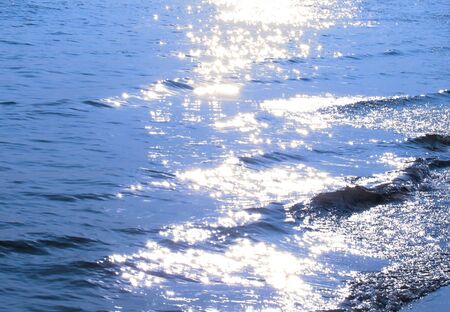 sunshine: patches of light over blue sea waves                     の写真素材