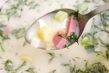 spoon with okroshka (cold whey soup with chopped vegatables and sausage) の写真素材
