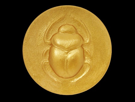 golden color egyptian amulet with image of scarab                           の写真素材