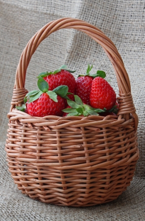 strawberry in a wicker basket on fabricの写真素材