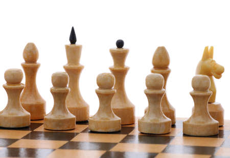 white chessmen on wooden chessboard over whiteの写真素材