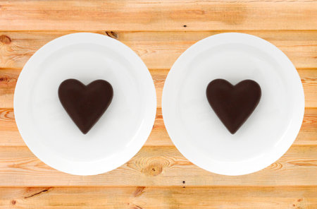 two chocolate valentines on platesの写真素材