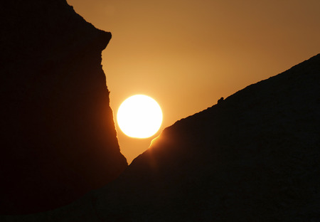 view on rising sun among two rocksの写真素材