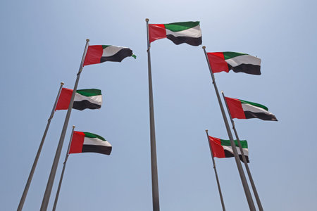 seven United Arab Emirates flags over blue sky