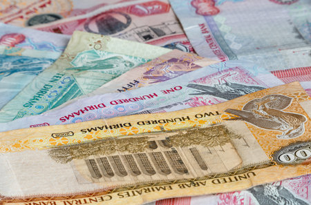 heap of United Arab Emirates banknotes: dirhams