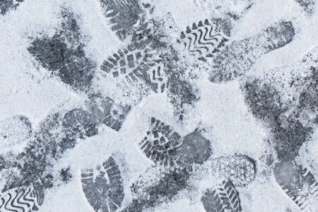 winter background with footprints on snowの写真素材